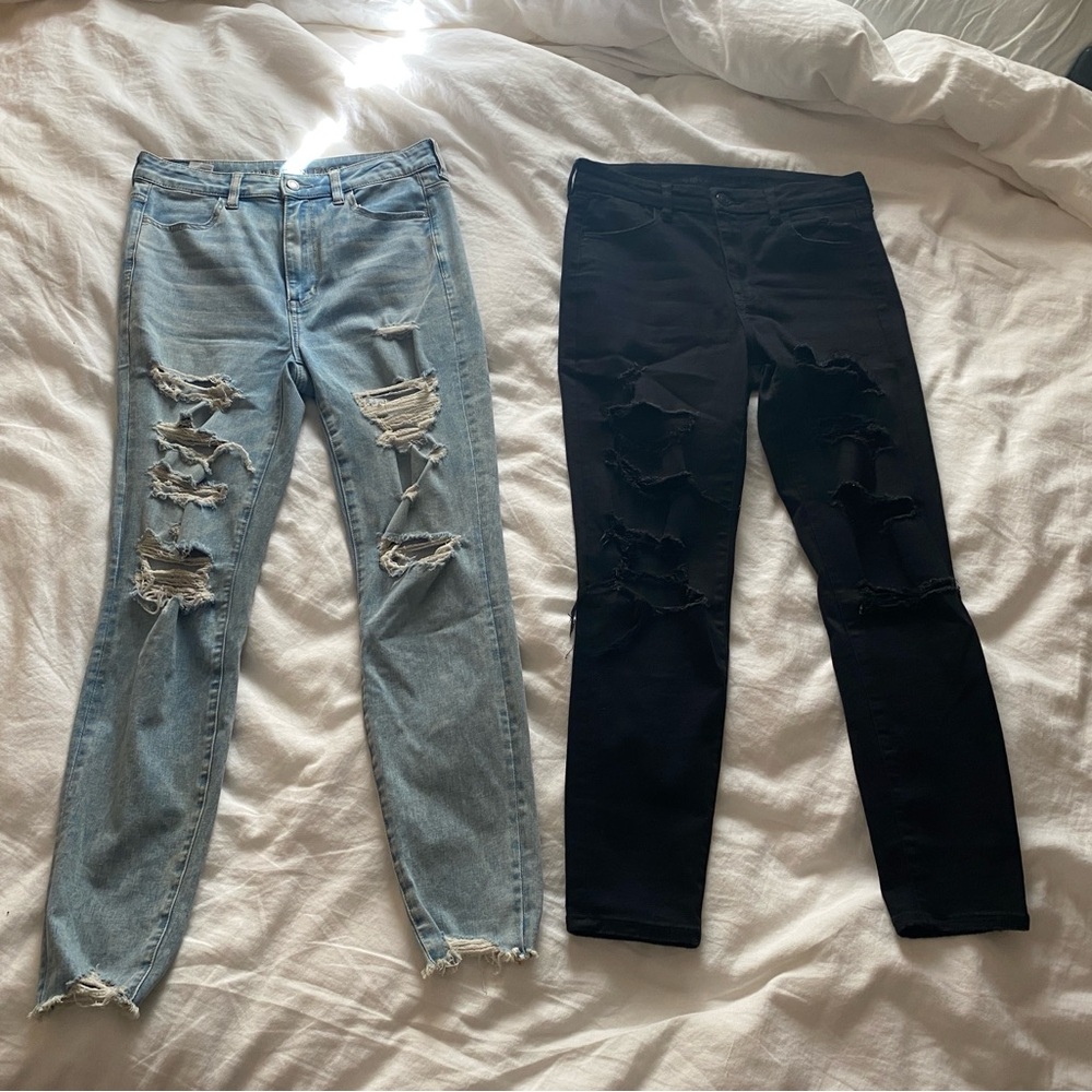 Two pair of American Eagle Outfitters distressed jeggings, blue denim & black.